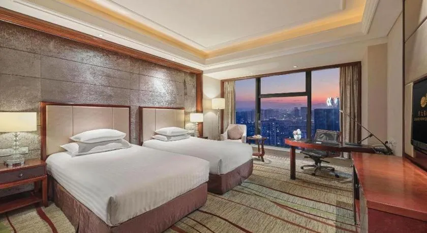 Bed in New Century Grand Hotel Zhejiang Sanli