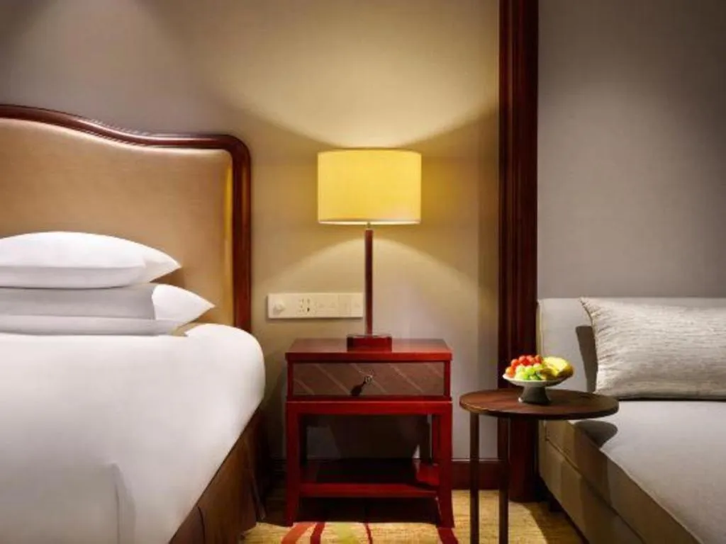 Bed in New Century Grand Hotel Zhejiang Sanli