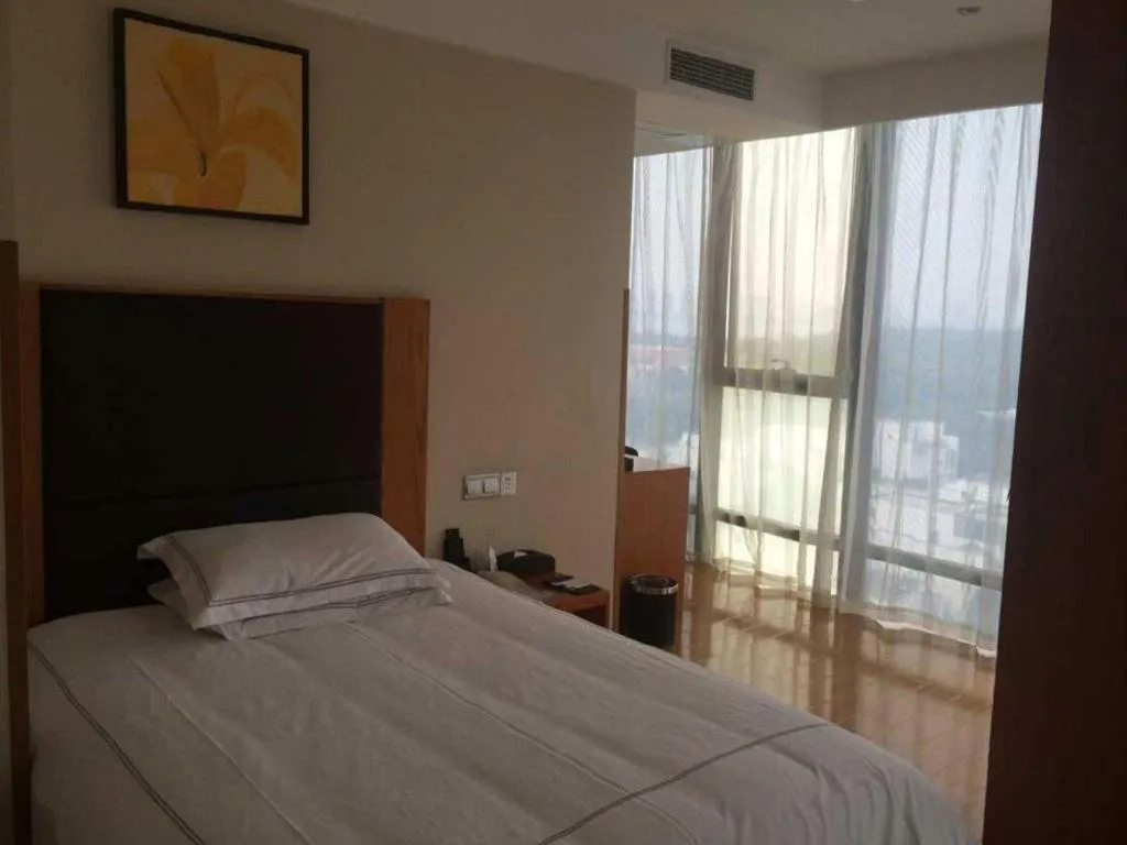 Bed in Warmly Hotel Suzhou Shuanghuwan