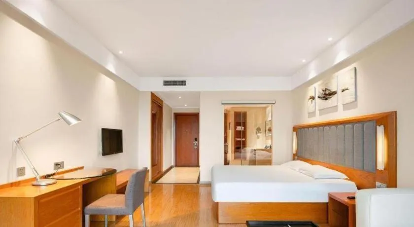 Bed in Warmly Hotel Suzhou Shuanghuwan