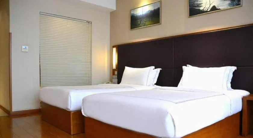 Bed in Warmly Hotel Suzhou Shuanghuwan