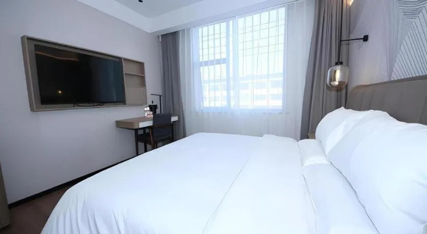 Bed in JUNYI Hotel Jiangxi Xinyu Baoshi Park