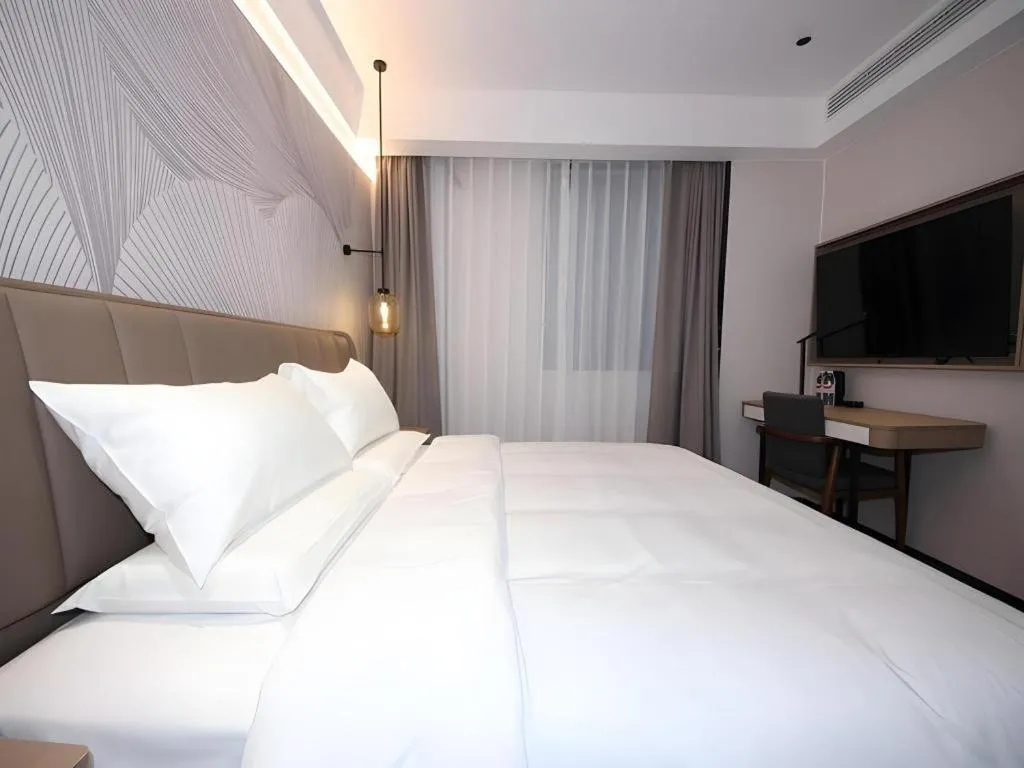 Bed in JUNYI Hotel Jiangxi Xinyu Baoshi Park