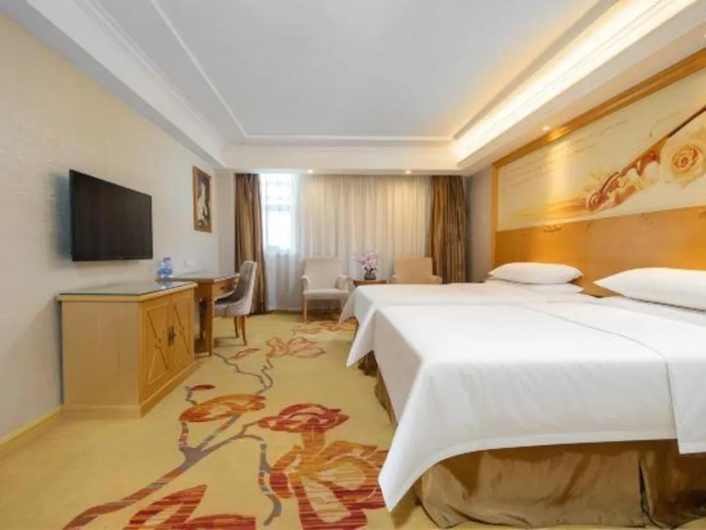 Bed in Vienna Hotel Shenzhen Longgang Baifucheng