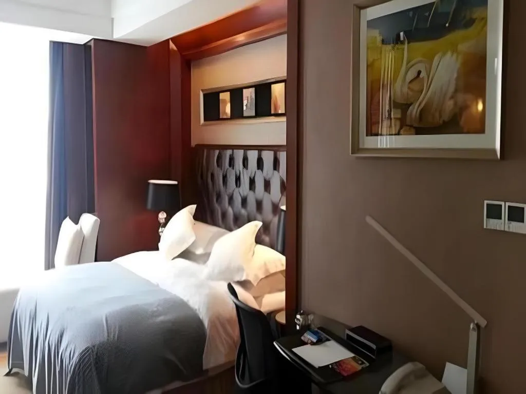 Bed in Maison New Century Hotel Wuyuan Haiyan