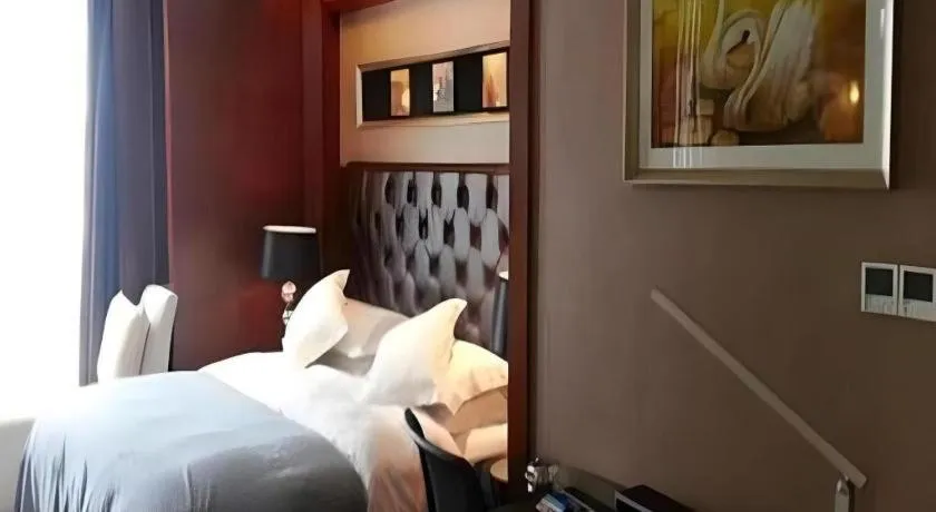 Bed in Maison New Century Hotel Wuyuan Haiyan