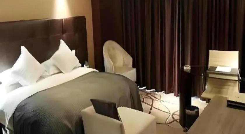 Bed in Maison New Century Hotel Wuyuan Haiyan