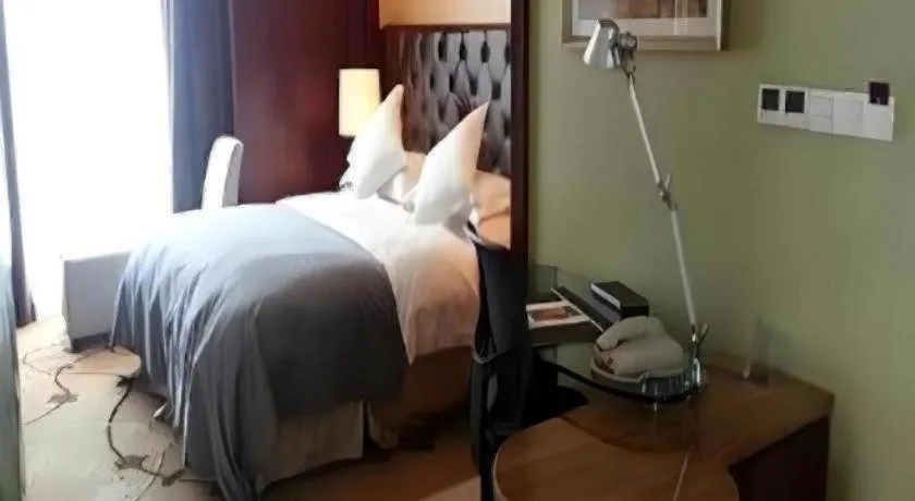 Bed in Maison New Century Hotel Wuyuan Haiyan