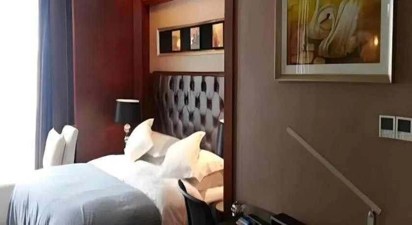 Bed in Maison New Century Hotel Wuyuan Haiyan