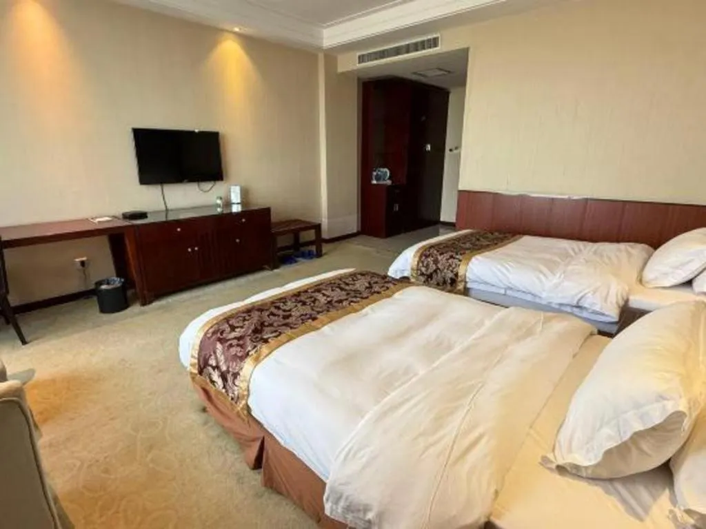 Bed in Xinxiang Zhongzhou Yihe Hotel