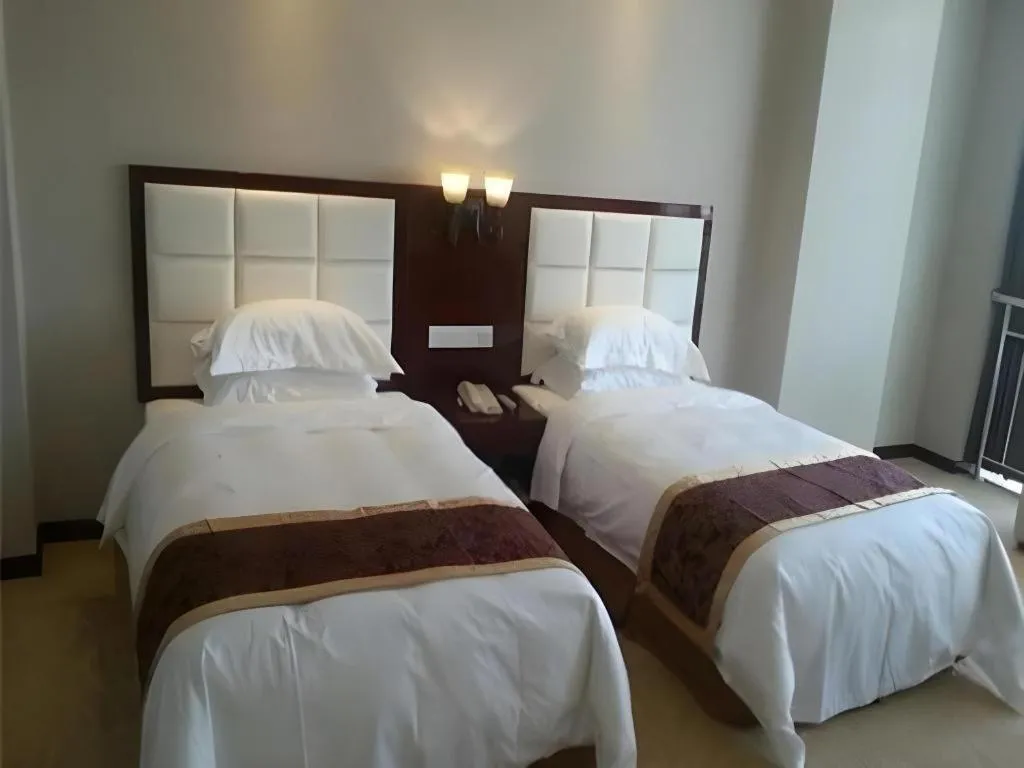 Bed in Xinxiang Zhongzhou Yihe Hotel