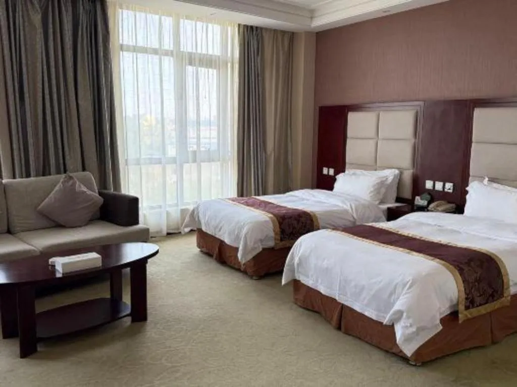 Bed in Xinxiang Zhongzhou Yihe Hotel