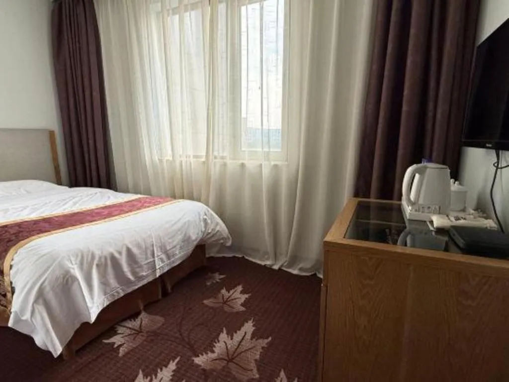 Bed in Xinxiang Zhongzhou Yihe Hotel