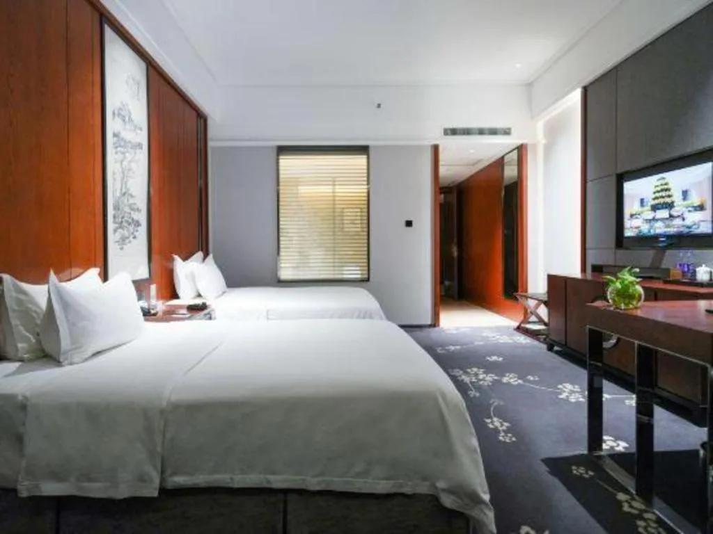 Bed in Jiyuan Oriental Jianguo Hotel