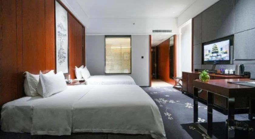 Bed in Jiyuan Oriental Jianguo Hotel