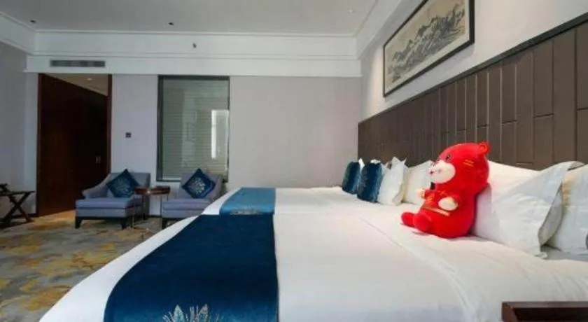 Bed in Jiyuan Oriental Jianguo Hotel