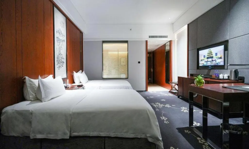 Bed in Jiyuan Oriental Jianguo Hotel