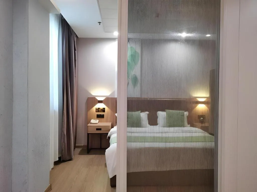 Bed in GreenTree Inn Jining Yanzhou Jiuzhou Fangyuan Business Hotel