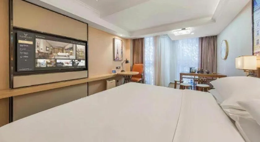 Bed in Vienna International Hotel Guangzhou Baiyun Dayuanli Plaza