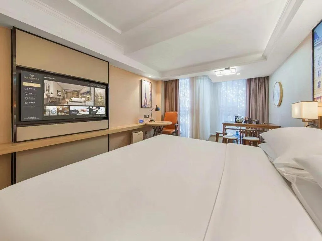 Bed in Vienna International Hotel Guangzhou Baiyun Dayuanli Plaza