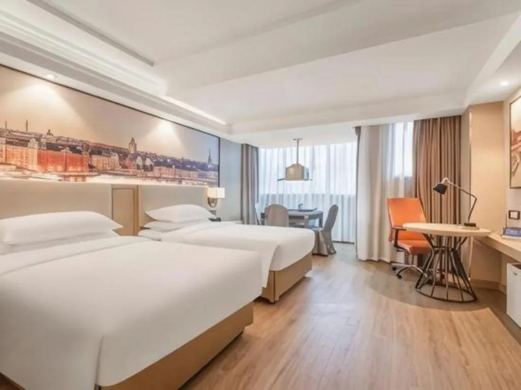 Bed in Vienna International Hotel Guangzhou Baiyun Dayuanli Plaza