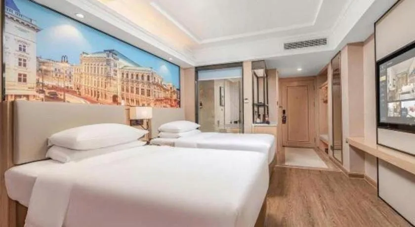 Bed in Vienna International Hotel Guangzhou Baiyun Dayuanli Plaza