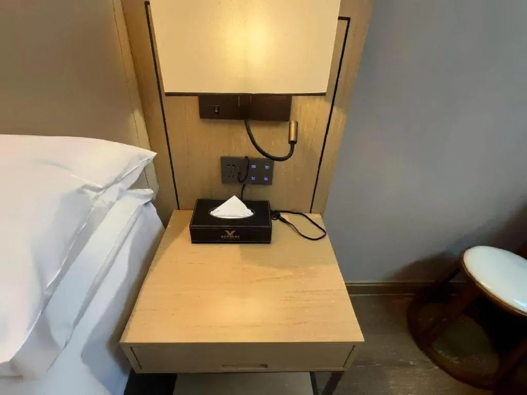 Bed in Vienna International Hotel Guangzhou Baiyun Dayuanli Plaza