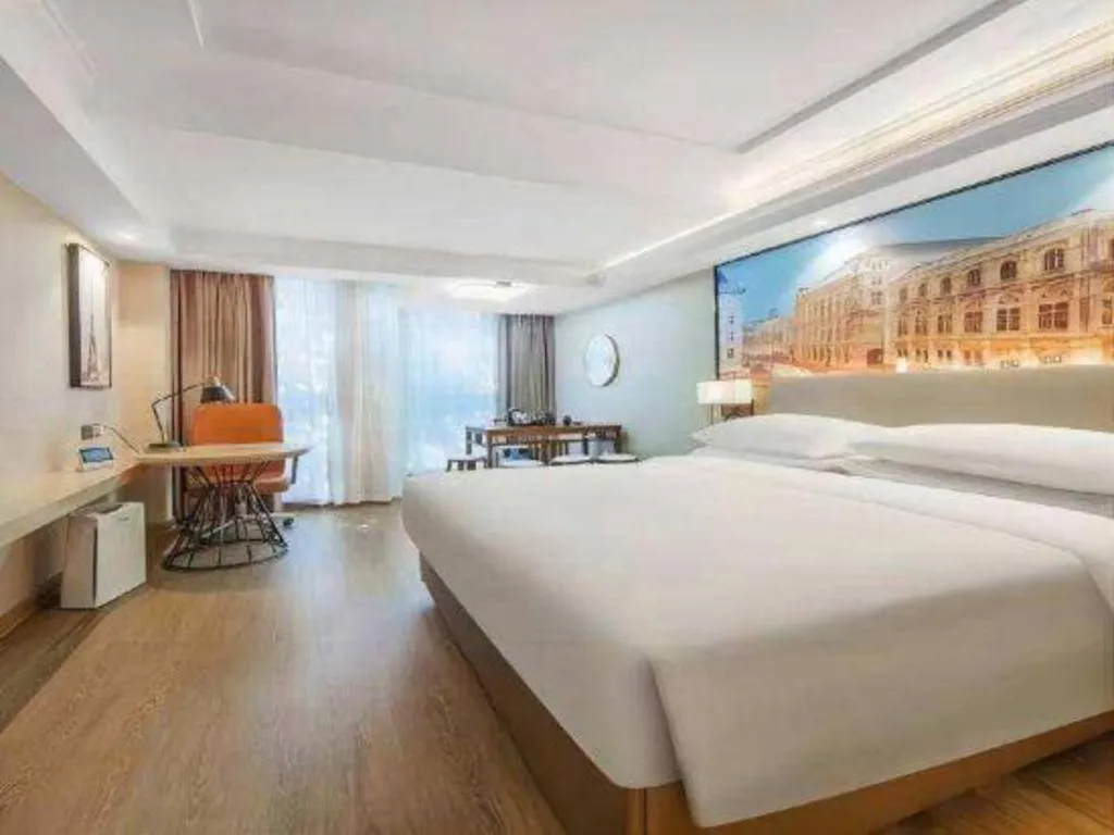 Bed in Vienna International Hotel Guangzhou Baiyun Dayuanli Plaza