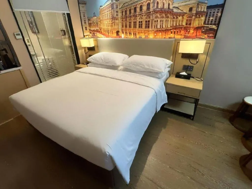 Bed in Vienna International Hotel Guangzhou Baiyun Dayuanli Plaza