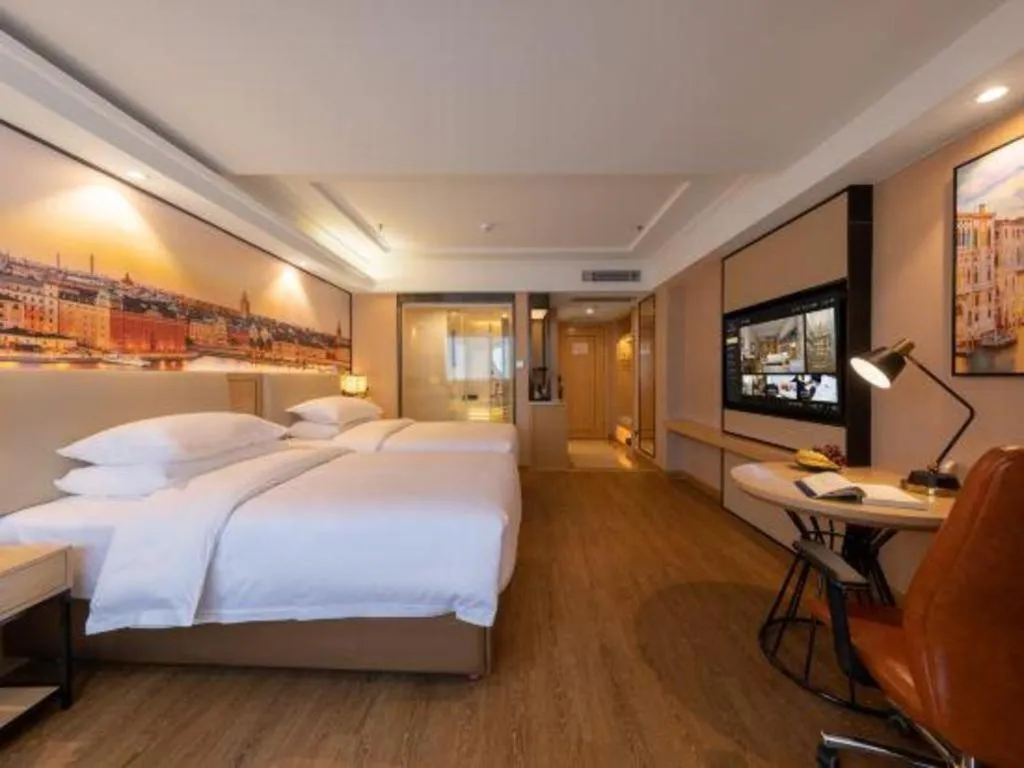 Bed in Vienna International Hotel Guangzhou Baiyun Dayuanli Plaza