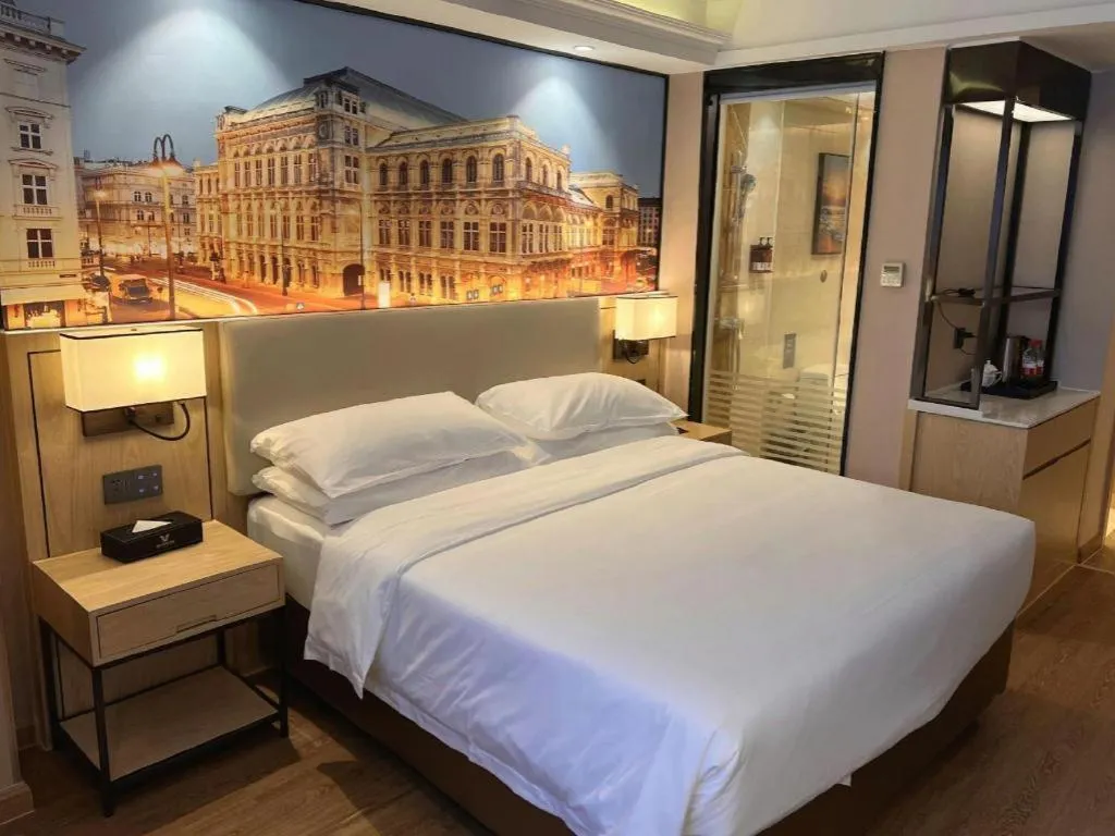 Bed in Vienna International Hotel Guangzhou Baiyun Dayuanli Plaza