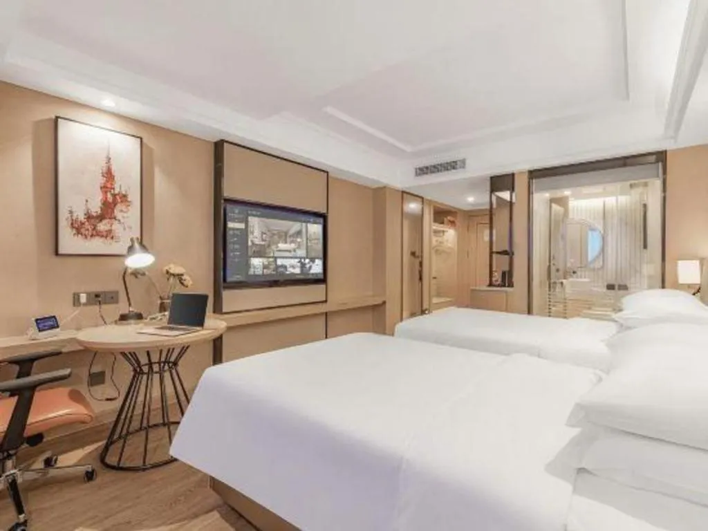 Bed in Vienna International Hotel Guangzhou Baiyun Dayuanli Plaza