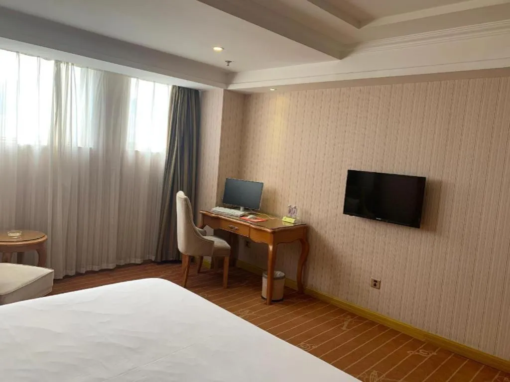 Bed in Vienna International Hotel Guangzhou Baiyun Dayuanli Plaza