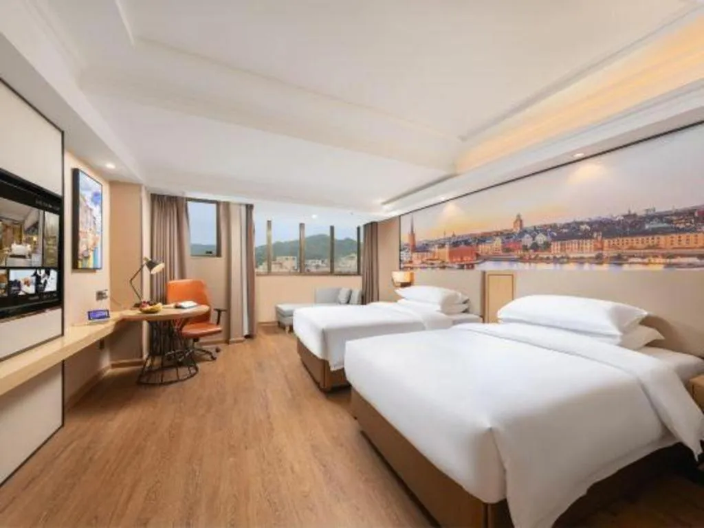 Bed in Vienna International Hotel Guangzhou Baiyun Dayuanli Plaza