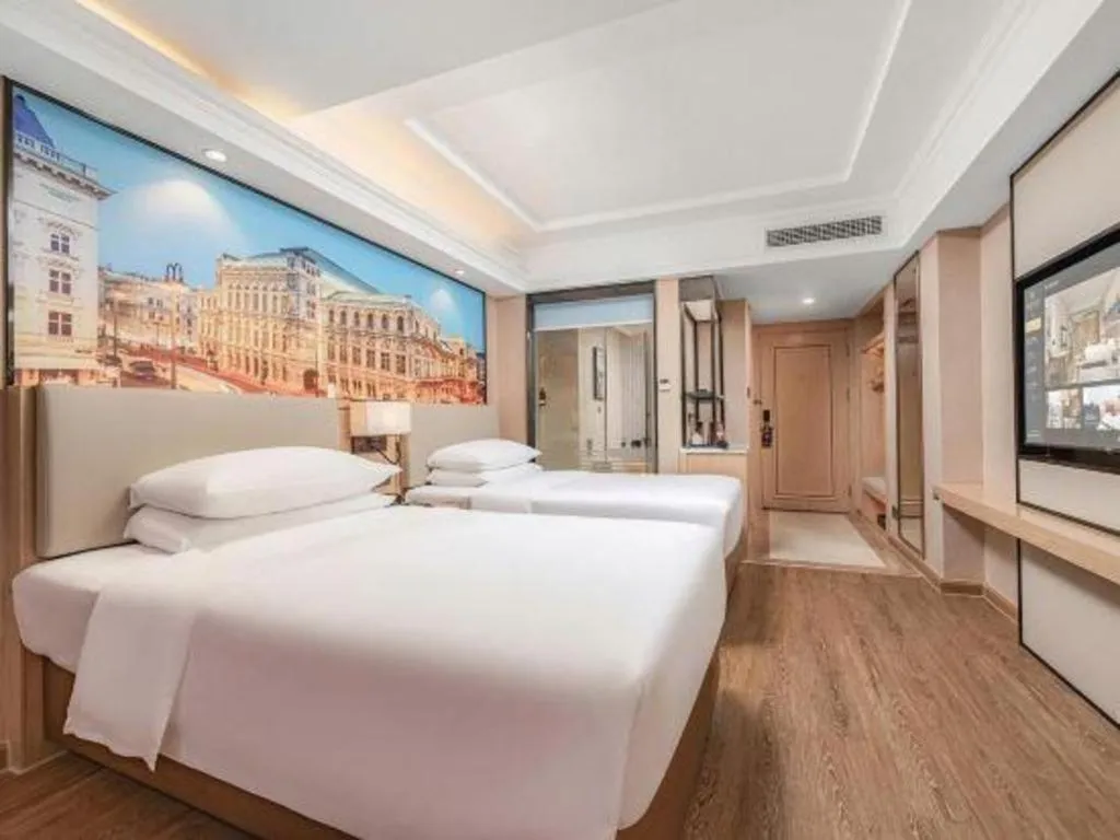 Bed in Vienna International Hotel Guangzhou Baiyun Dayuanli Plaza