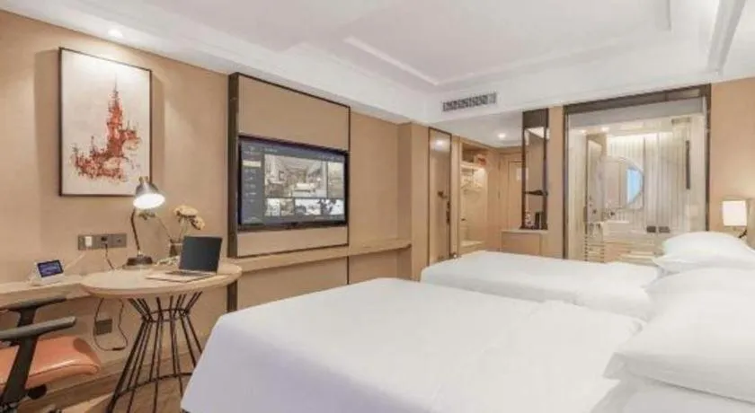 Bed in Vienna International Hotel Guangzhou Baiyun Dayuanli Plaza