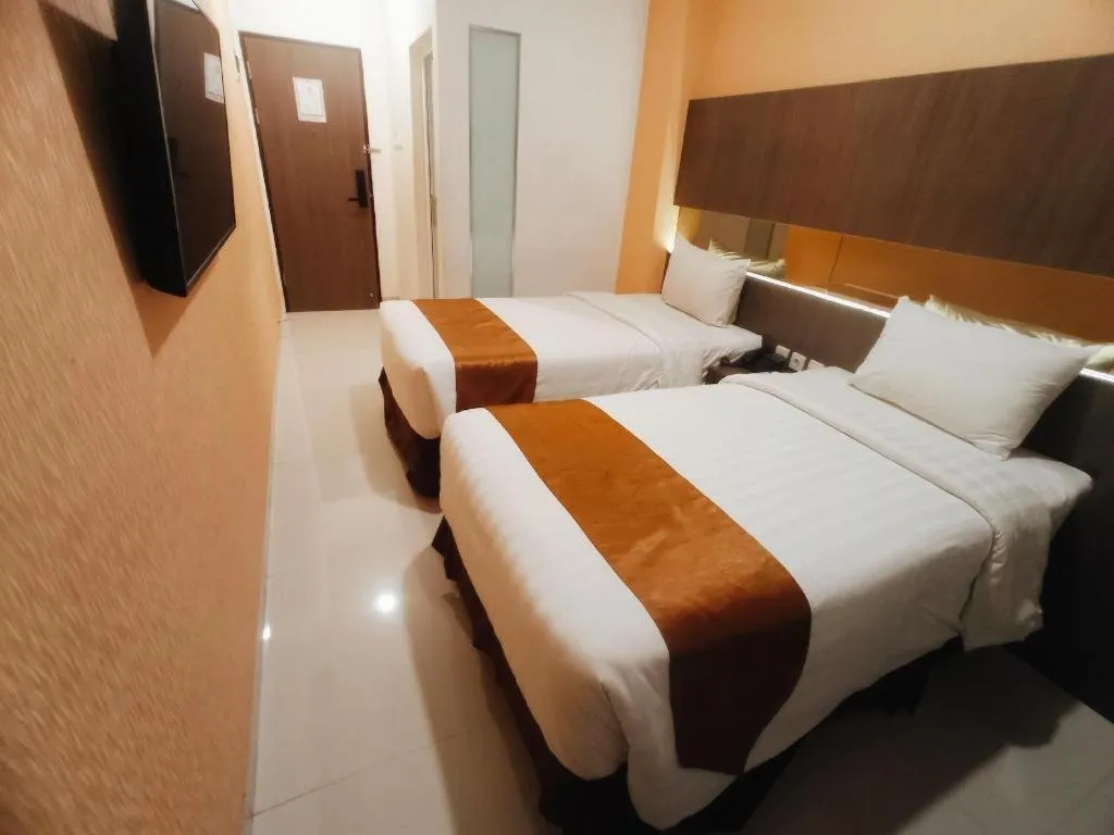 Bed in NIVIA HOTEL