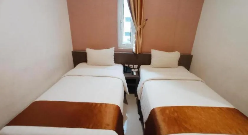 Bed in NIVIA HOTEL