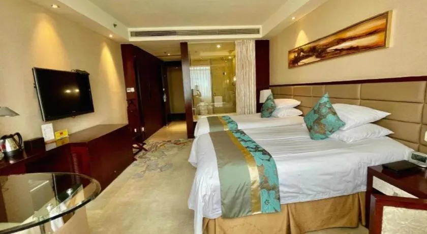 Bed in New Century Grand Hotel Lishui Huaqiao