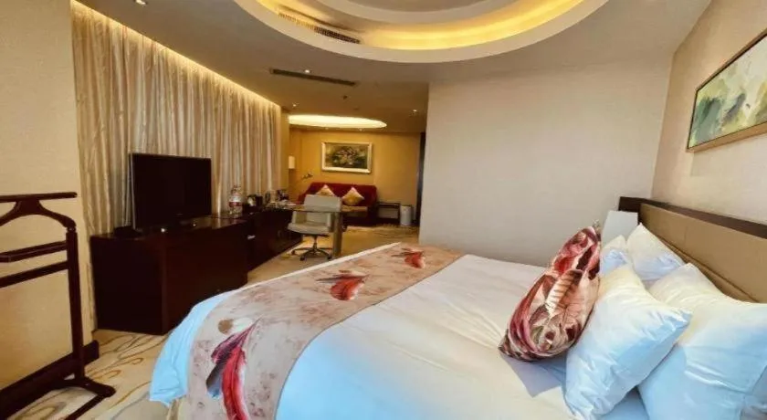 Bed in New Century Grand Hotel Lishui Huaqiao