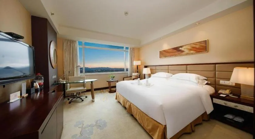 Bed in New Century Grand Hotel Lishui Huaqiao
