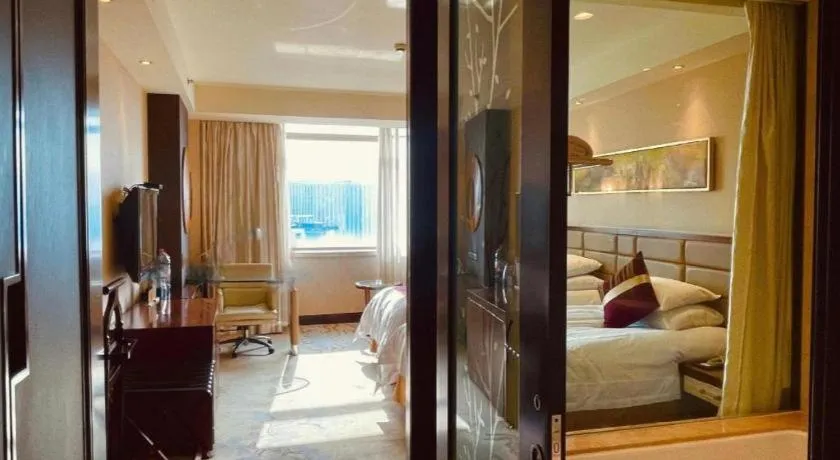 Bed in New Century Grand Hotel Lishui Huaqiao