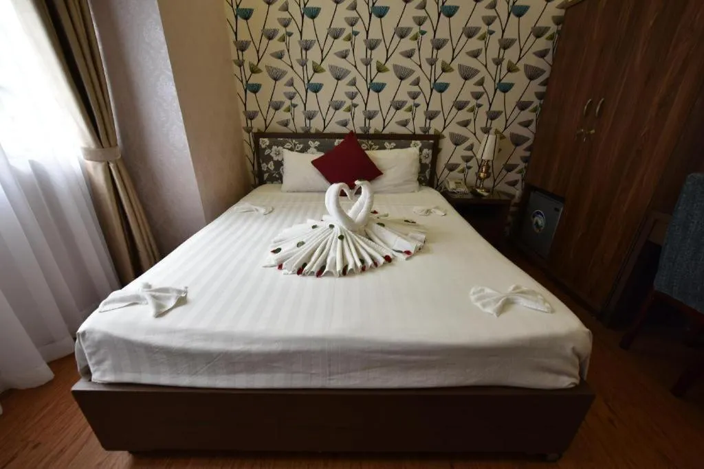 Bed in Helios Legend Hotel