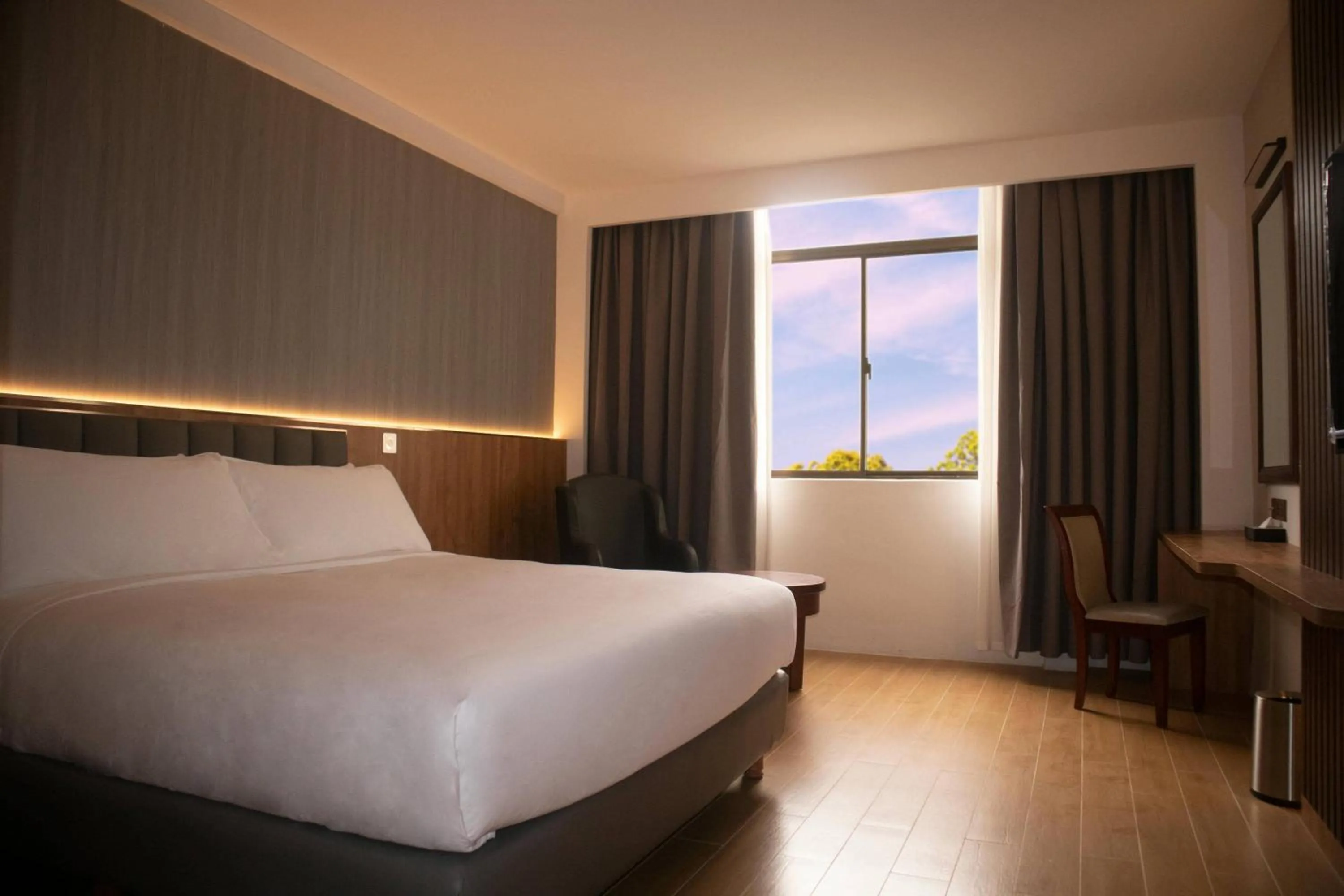 Bed in Aglow Hotel Harbor Bay Batam