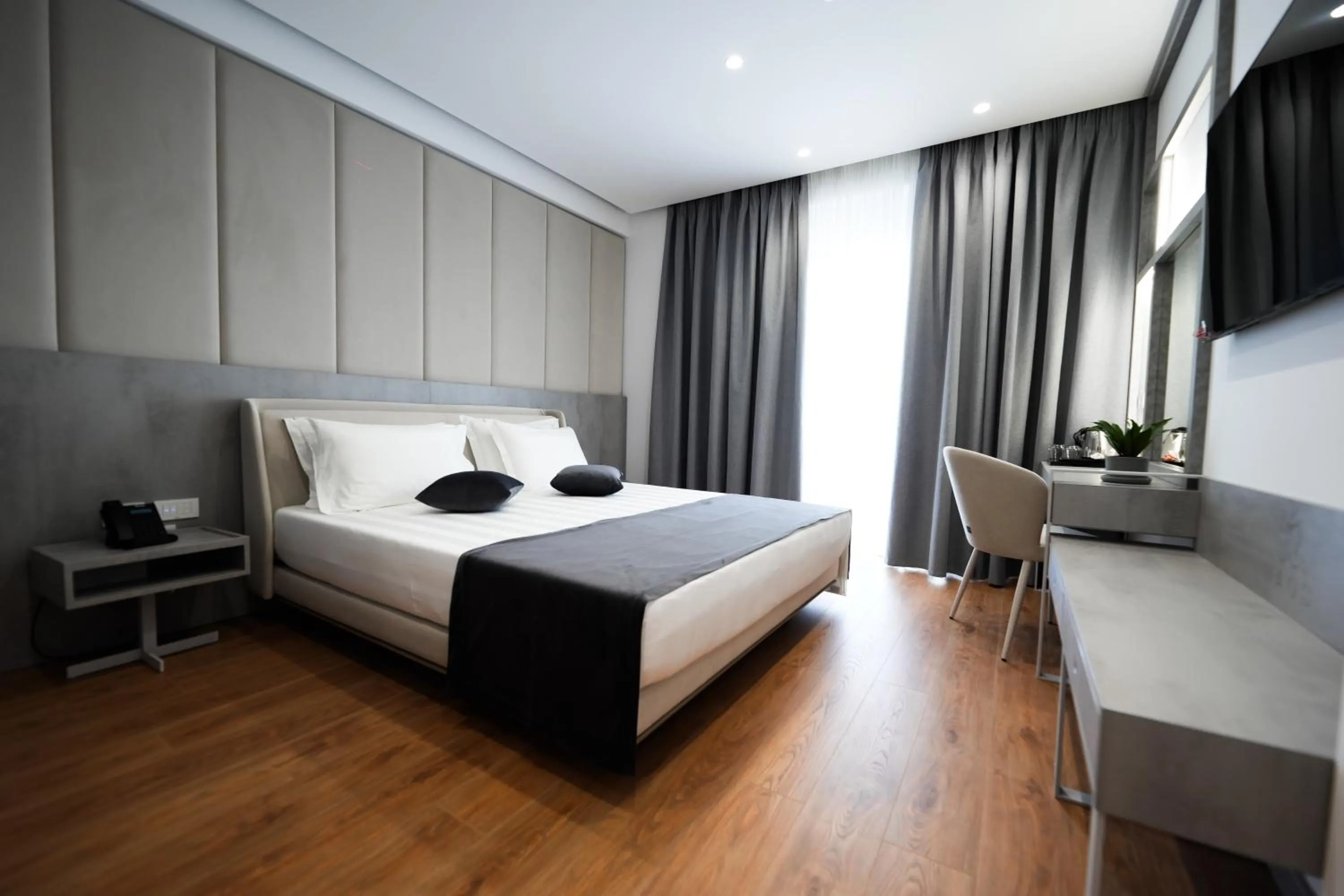 Bed in Naos Luxury Hotel