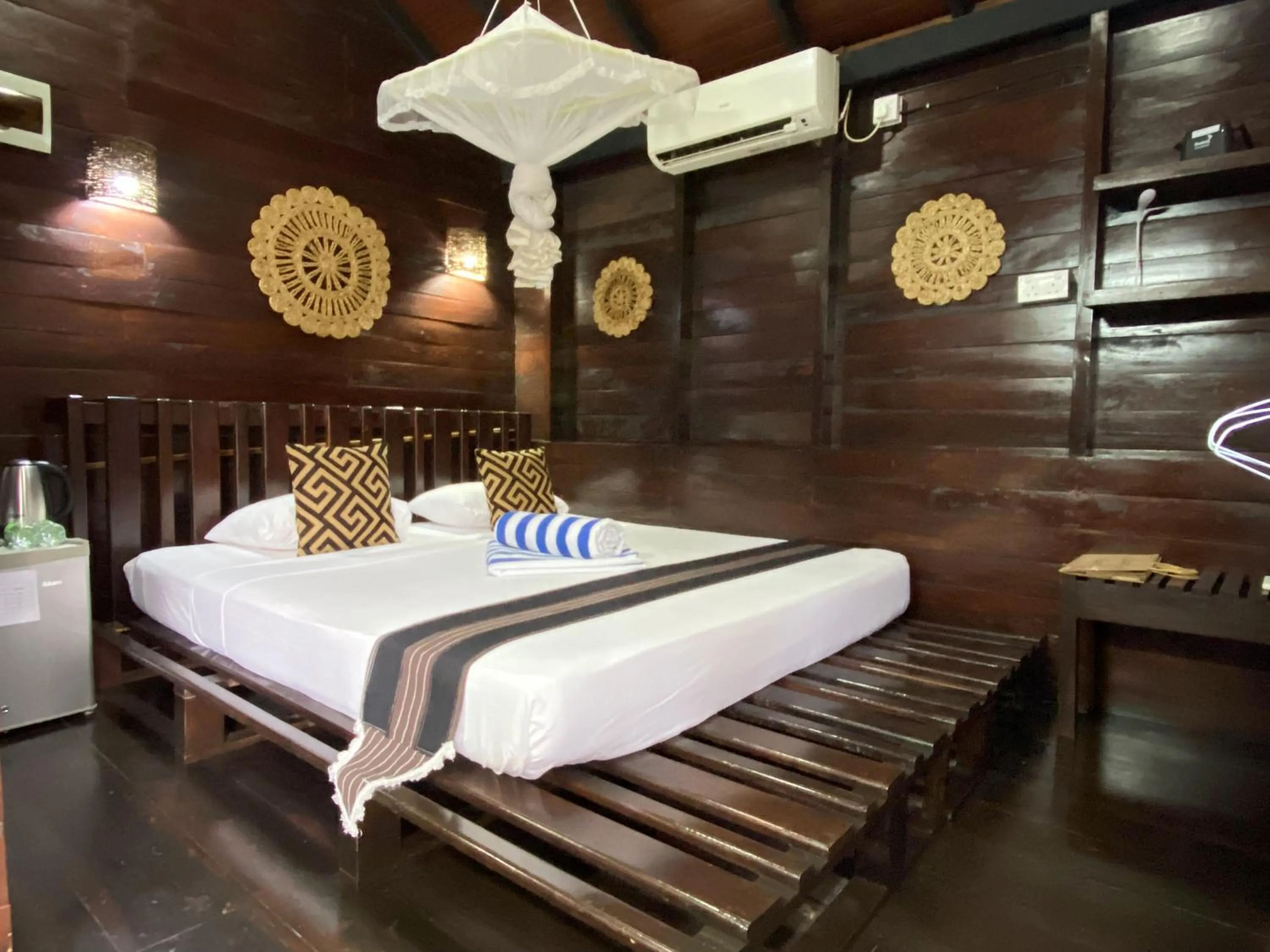 Bed in Coco Palm Villa and Cabanas
