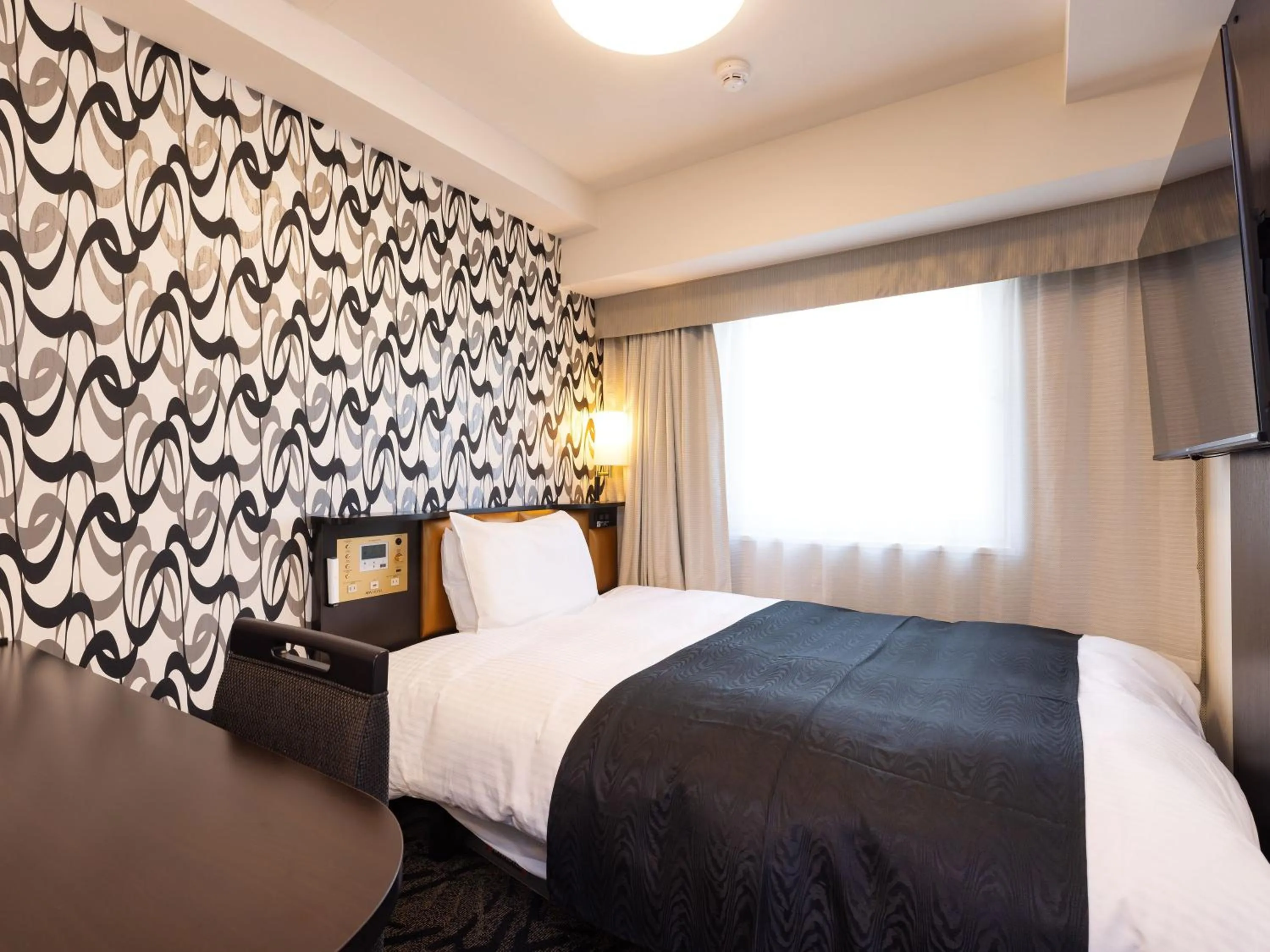 Photo of the whole room, Bed in APA Hotel Hiroshima Ekimae Stadiumguchi