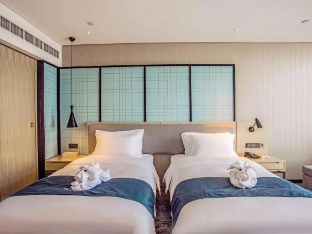 Bed in Echarm Hotel Qionghai Wanquan River