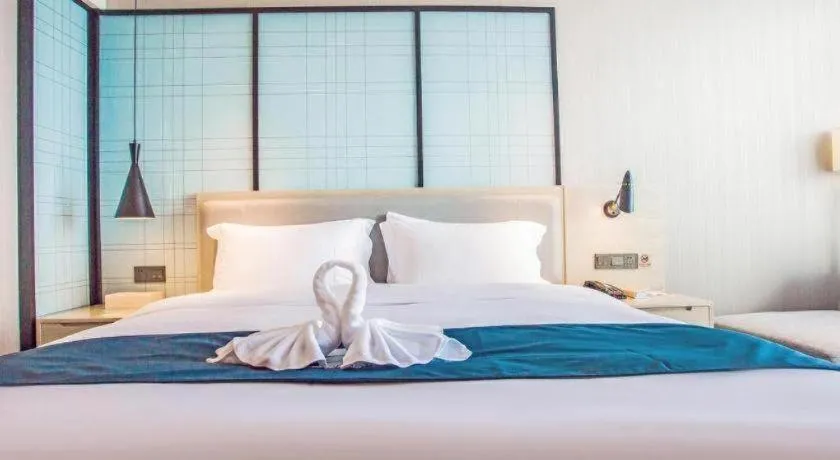 Bed in Echarm Hotel Qionghai Wanquan River