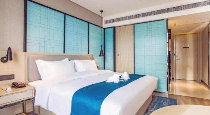 Bed in Echarm Hotel Qionghai Wanquan River